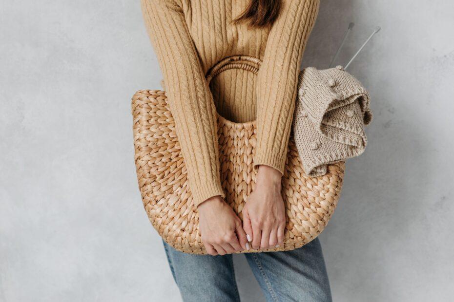 Illustration of A Textured Handbag Beside a Simple Women's Outfit: Exploring Contrast Without Adding More Clothing Layers